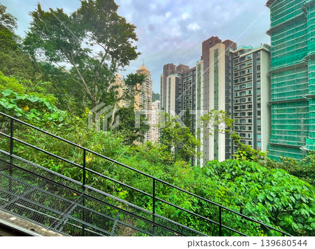 Hong Kong - Scenery from the Peak Tram as it ascends a steep slope. Hong Kong - Scenery from the Peak Tram as it ascends a steep slope. 139680544