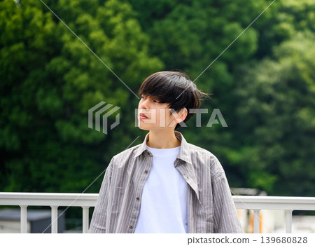 Portrait of a young man against a green background Portrait of a young man against a green background 139680828