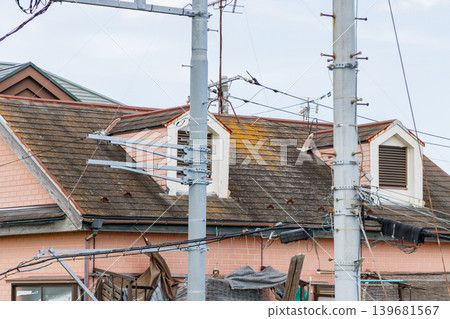 A house with a roof damaged by moss and decay. A house with a roof damaged by moss and decay. 139681567