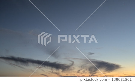 A serene sunrise sky with a deep blue-to-orange gradient and wispy clouds near the horizon. A single bright star or planet is visible in the upper center of the frame. A serene sunrise sky with a deep blue-to-orange gradient and wispy clouds near the horizon. A single bright star or planet is visible in the upper center of the frame. 139681861