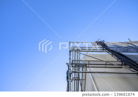 A house after exterior wall renovation that takes advantage of the open space under the blue sky. A house after exterior wall renovation that takes advantage of the open space under the blue sky. 139681874