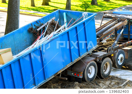 Truck unloads debris at construction site in neighborhood Truck unloads debris at construction site in neighborhood 139682403