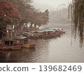 A peaceful collection of Japanese autumn landscapes featuring colorful maple trees, traditional temples, bamboo forests, and serene garden paths. These images capture the calm beauty of nature, warm 139682469