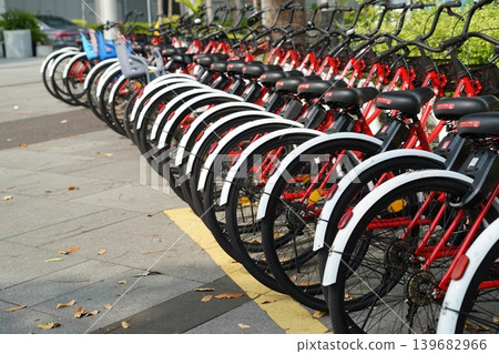 Row of Shared Bicycles on Pavement Urban Scene Row of Shared Bicycles on Pavement Urban Scene 139682966