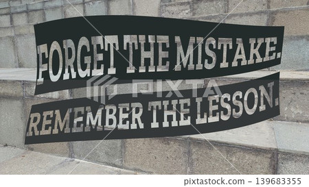 An uplifting quote, FORGET THE MISTAKE, REMEMBER THE LESSON, displayed on a black banner over grey outdoor steps, symbolizing learning and moving forward. 139683355