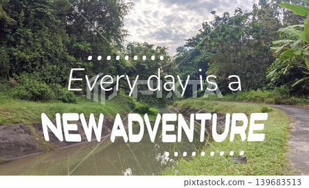 A motivating quote, Every day is a NEW ADVENTURE, set against a lush, green landscape with a small river, inspiring a sense of exploration and new possibilities. A motivating quote, Every day is a NEW ADVENTURE, set against a lush, green landscape with a small river, inspiring a sense of exploration and new possibilities. 139683513