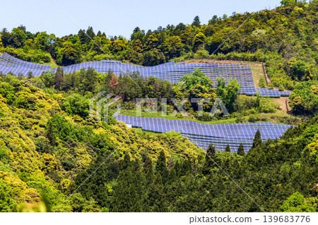 A mega solar power plant in the middle of nature, surrounded by greenery. A mega solar power plant in the middle of nature, surrounded by greenery. 139683776