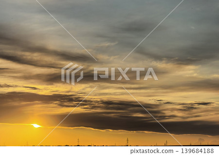 Golden Sunset Glowing Through Dark Evening Clouds 139684188