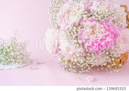 A flower basket of pink peonies and baby's breath A flower basket of pink peonies and baby's breath 139685325