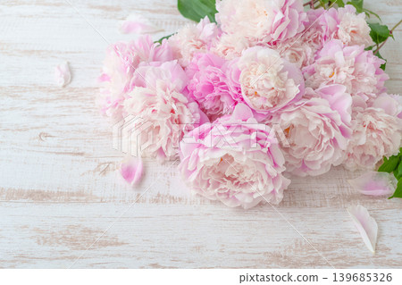 Pink peonies placed on a wooden table Pink peonies placed on a wooden table 139685326