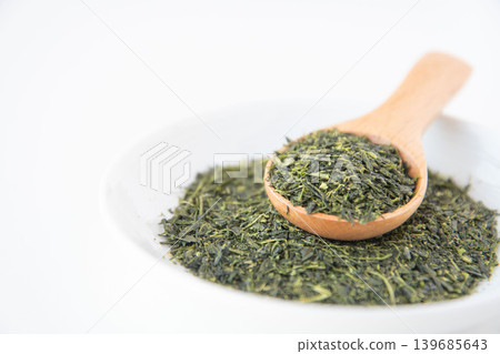 Close-up of green tea leaves served on a small plate. Close-up of green tea leaves served on a small plate. 139685643