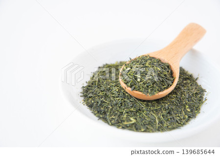 Close-up of green tea leaves served on a small plate. Close-up of green tea leaves served on a small plate. 139685644