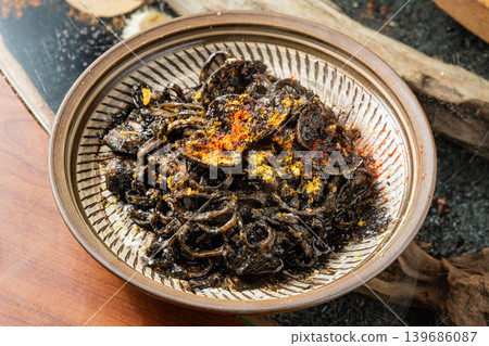 Squid ink pasta: Black spaghetti with a rich, savory flavor. Squid ink pasta: Black spaghetti with a rich, savory flavor. 139686087