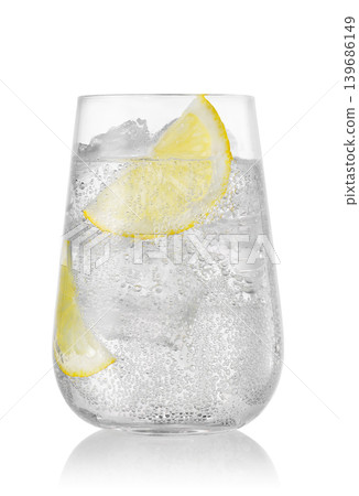 Glass of sparkling water with lemon and ice isolated on white background Glass of sparkling water with lemon and ice isolated on white background 139686149