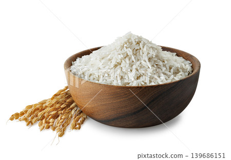 White rice grains in rustic wooden bowl with dry rice stalks isolated on white background 139686151