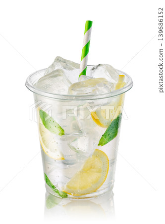 Lemonade in transparent disposable plastic cup with ice, lemon slices and fresh mint leaves isolated on white background Lemonade in transparent disposable plastic cup with ice, lemon slices and fresh mint leaves isolated on white background 139686152