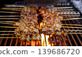 grilled pork intestines skewers on hot flames in street food market  139686720