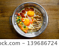 pan-fried egg with toppings on wooden table 139686724