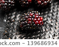 A ripe blueberry on the textured surface of black plastic retail packaging 139686934