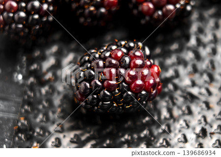 A ripe blueberry on the textured surface of black plastic retail packaging 139686934