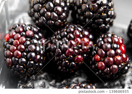 Dark ripe blueberries in a clear plastic market pack. Close-up shot. 139686935
