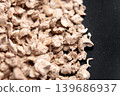 Scattered particles of biodegradable vegetable cat litter on a black surface. Macro 139686937