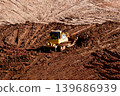 Heavy industrial bulldozer working on massive construction site moving soil 139686939
