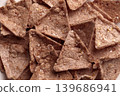 Crispy organic buckwheat nachos with amaranth and quinoa. Triangular tortilla chips with crunchy texture. Gluten-free snack. Top view.  139686941
