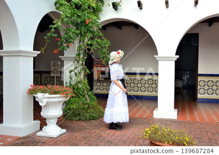 A woman standing in the home of a Peruvian plantation owner. A woman standing in the home of a Peruvian plantation owner. 139687284