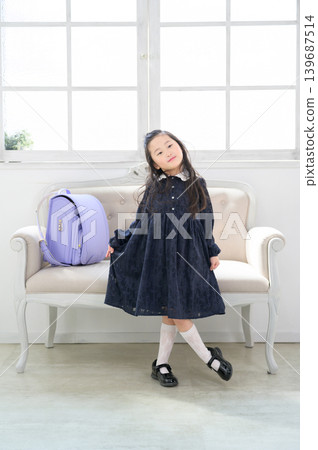 A Japanese girl spreads her skirt in front of the sofa. A Japanese girl spreads her skirt in front of the sofa. 139687514