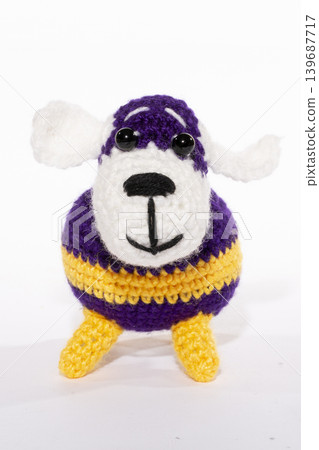 Knitted woolen dog on a white background Knitted woolen dog on a white background 139687717