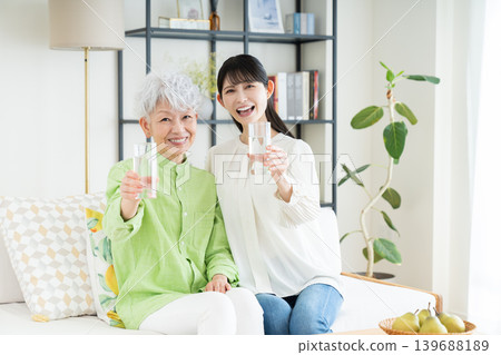 Senior and middle-aged women drinking mineral water Senior and middle-aged women drinking mineral water 139688189