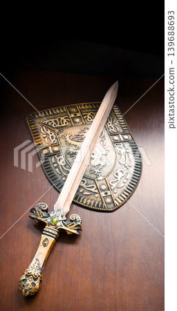 Iron shield and sword on the table Iron shield and sword on the table 139688693