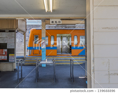 The simple ticket gate and parked train at Nagareyama Station on the Ryutetsu Nagareyama Line. The simple ticket gate and parked train at Nagareyama Station on the Ryutetsu Nagareyama Line. 139688896