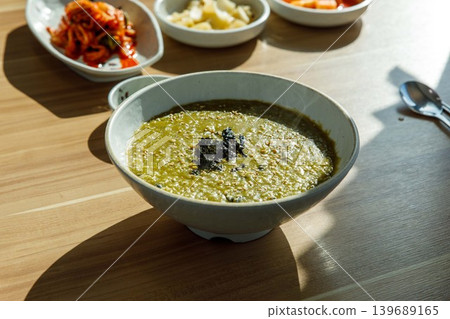 Traditional Jeju Sea Snail Porridge in a Ceramic Bowl Traditional Jeju Sea Snail Porridge in a Ceramic Bowl 139689165