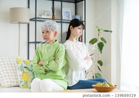A senior mother and her middle-aged daughter have a fight. A senior mother and her middle-aged daughter have a fight. 139689319