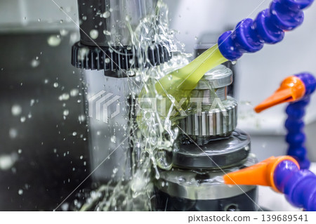 Industrial coolant spraying on CNC metal machining process. Industrial coolant spraying on CNC metal machining process. 139689541