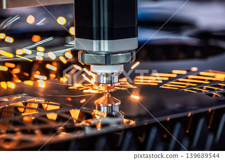 Industrial CNC laser cutting machine with flying sparks in metal fabrication. Industrial CNC laser cutting machine with flying sparks in metal fabrication. 139689544