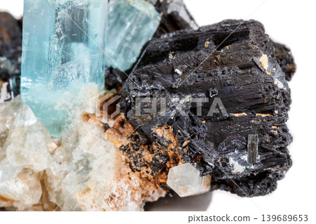 Macro mineral stone Aquamarine and black tourmaline, Schorl on a white background Macro mineral stone Aquamarine and black tourmaline, Schorl on a white background 139689653