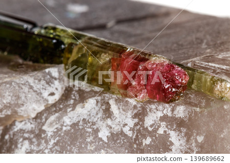 Macro mineral tourmaline stone in quartz on a white background Macro mineral tourmaline stone in quartz on a white background 139689662