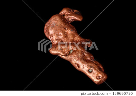 Macro mineral stone of a copper nugget on a microcline on a black background Macro mineral stone of a copper nugget on a microcline on a black background 139690750