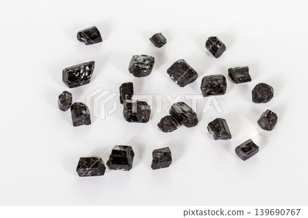 macro mineral stone schorl, black tourmaline on white background macro mineral stone schorl, black tourmaline on white background 139690767