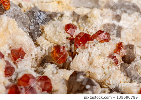 Macro mineral stone Spessartine, Feldspar, Smoky quartz, on a white background Macro mineral stone Spessartine, Feldspar, Smoky quartz, on a white background 139690789