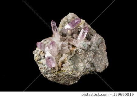 Macro mineral stone Amethyst crystals in rock on a black background Macro mineral stone Amethyst crystals in rock on a black background 139690819