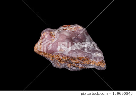 Macro pink Smithsonite mineral stone on microcline on black background Macro pink Smithsonite mineral stone on microcline on black background 139690843