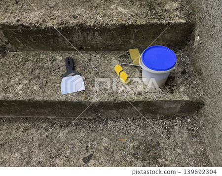 Paint Scraper and Roller on Concrete Steps Paint Scraper and Roller on Concrete Steps 139692304