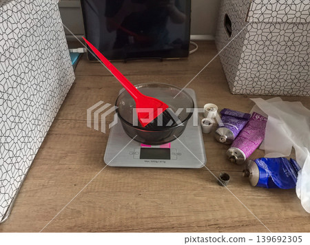 Hair dye preparation kit with bowl, brush, and tubes on a scale Hair dye preparation kit with bowl, brush, and tubes on a scale 139692305