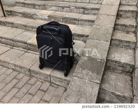 Black Suitcase on Stone Stairs Black Suitcase on Stone Stairs 139692320