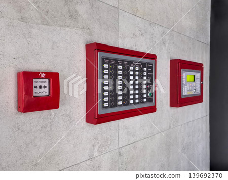 Fire alarm control panel on the wall in a public building Fire alarm control panel on the wall in a public building 139692370