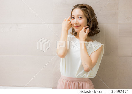 Young woman looking at a mirror Young woman looking at a mirror 139692475